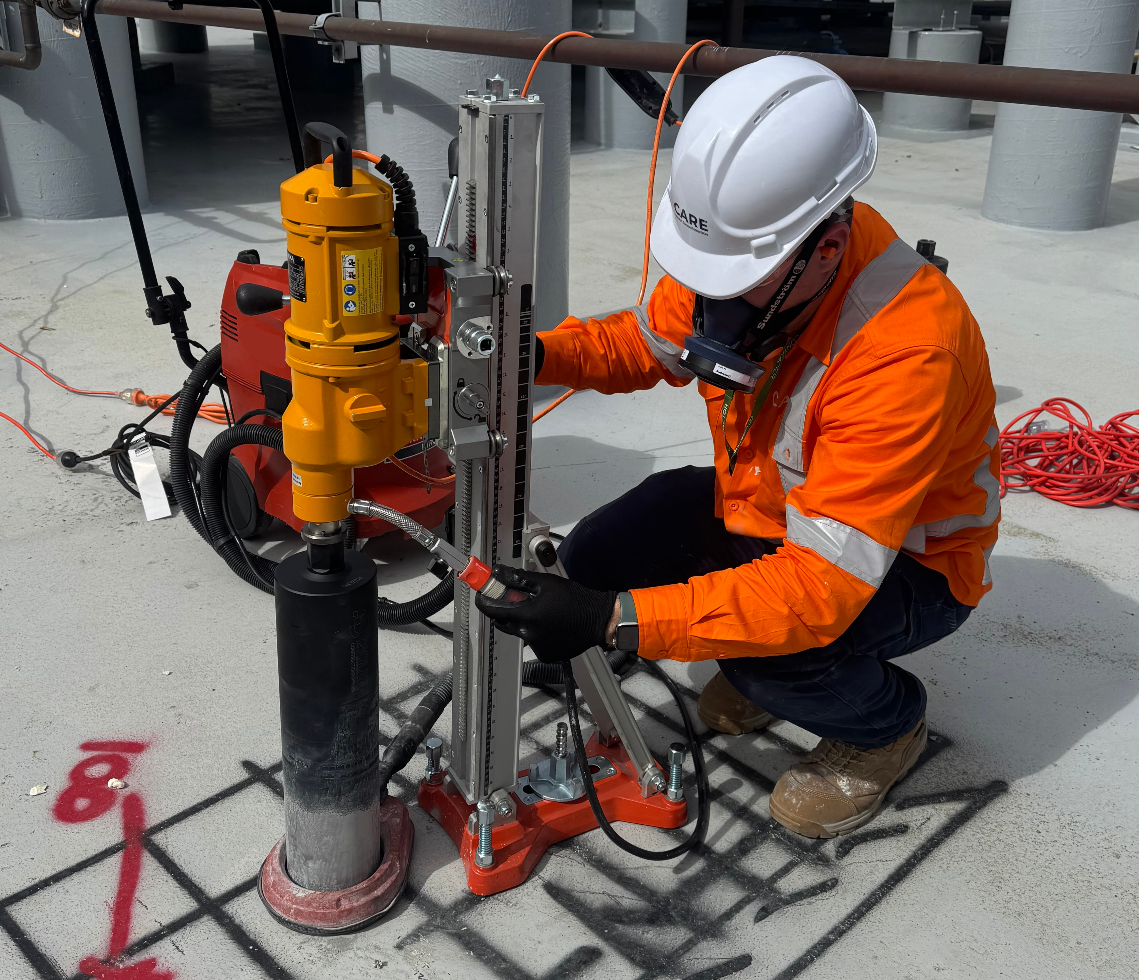 Diamond core drilling rig set up on a concrete slab